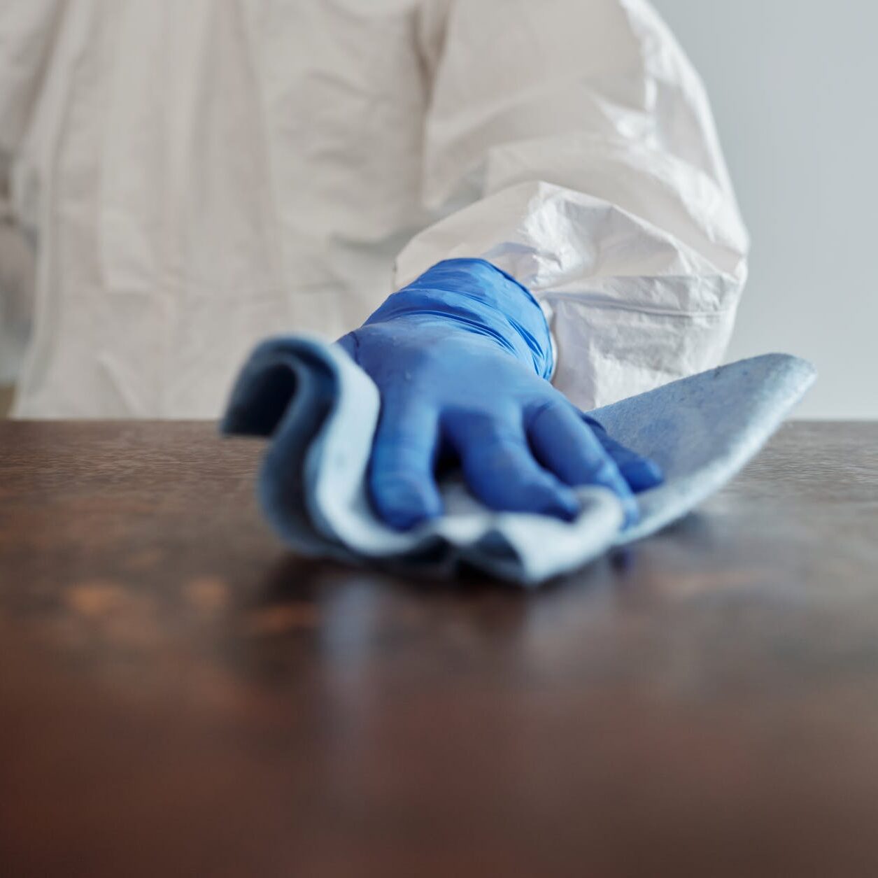 close up photo of person cleaning the table